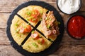 potato pancakes with bacon, tomatoes, onions and sauces close-up. Horizontal top view Royalty Free Stock Photo