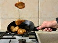 Potato pancakes in the cooking process. Fried pancakes in an old pan, on a gas stove. Cooked pies in a pan in oil. Royalty Free Stock Photo