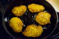 Potato pancakes, draniki, hash browns or fritters frying in old cast iron pan, skillet, selective focus Royalty Free Stock Photo