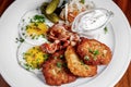 Potato pancakes with fried eggs, bacon and vegetables for breakfast Royalty Free Stock Photo