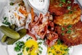 Potato pancakes with fried eggs, bacon and vegetables for breakfast Royalty Free Stock Photo