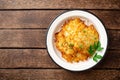 Potato pancakes or latkes or draniki in plate on dark wooden table. Top view. Copy space. Royalty Free Stock Photo