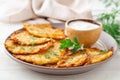 Potato pancakes or latkes or draniki with sour cream in plate on white wooden table Royalty Free Stock Photo
