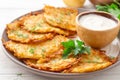 Potato pancakes or latkes or draniki with sour cream in plate on white wooden table Royalty Free Stock Photo