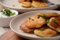 Potato pancakes or latkes or draniki with sour cream in plate on wooden table Royalty Free Stock Photo