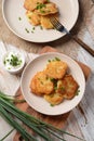 Potato pancakes or latkes or draniki with sour cream in plate on wooden table Royalty Free Stock Photo