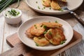 Potato pancakes or latkes or draniki with sour cream in plate on wooden table Royalty Free Stock Photo