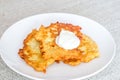 Potato pancakes  raggmunk  draniki  deruny  latkes or boxties on white plate. Polish placki ziemniaczane with sour cream Royalty Free Stock Photo