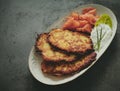 Potato pancakes and salmon with lettuce