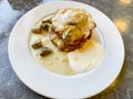 Potato pancakes, sauce with mushrooms in white plate. Studio Photo. Royalty Free Stock Photo