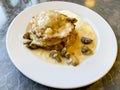Potato pancakes, sauce with mushrooms in white plate. Studio Photo. Royalty Free Stock Photo