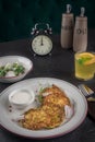 Potato pancakes on a white plate. Fresh vegetable salade and lemonade drink. Lunch time 12pm Royalty Free Stock Photo