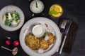 Potato pancakes on a white plate. Fresh vegetable salade and lemonade drink. Lunch time 12pm Royalty Free Stock Photo