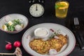 Potato pancakes on a white plate. Fresh vegetable salade and lemonade drink. Lunch time 12pm Royalty Free Stock Photo