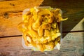 Potato peel in a plastic container, close-up. Food waste sorted separately. Composting leftovers after peeling potatoes