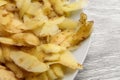 Potato peel on white kitchen plate. Food waste Royalty Free Stock Photo
