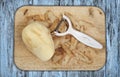 Potato peeled and prepared on a chopping board
