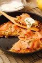 Potato pizza with salmon and cream in black pan Royalty Free Stock Photo