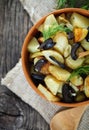 Potato salad with olives, onion, dill