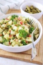 Potato salad with pickled cucumbers, parsley and mustard sauce
