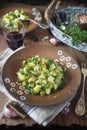 Potato salad with pickled cucumbers, parsley and olive oil, rustic style