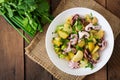 Potato salad with pickled octopus and onions Royalty Free Stock Photo