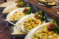 Potato salad in a white dish on open buffet