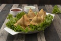 Potato Samosa Snacks on wooden textured Background. Indian Ramadan Food, Pakistani Iftar Meal. Royalty Free Stock Photo