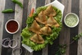 Potato Samosa Snacks on wooden textured Background. Indian Ramadan Food, Pakistani Iftar Meal. top view Royalty Free Stock Photo