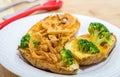 Potato Skins appetizer closeup with broccoli, cheddar cheese and fried onions Royalty Free Stock Photo