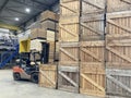 Potato storage facility. Forklift used to stack the crates. Refrigerated cold warehouse for potatoes and onions with wooden boxes. Royalty Free Stock Photo