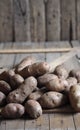 Potato tubers on a wooden background close-up. Storage of potatoes in a wooden box Royalty Free Stock Photo