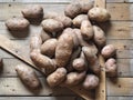 Potato tubers on a wooden background close-up. Storage of potatoes in a wooden box Royalty Free Stock Photo