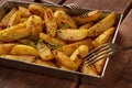 Potato wedges, oven roasted, close-up in baking tray Royalty Free Stock Photo