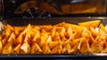 Potato wedges, oven roasted with spices in a baking tray