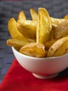 Potato wedges in a white bowl