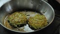 Potato and zucchini pancakes are fried in a pan, frying potato pancakes in oil, pan frying close-up, vegetarian food Royalty Free Stock Photo