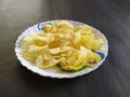 Potatochips in a plate, blackbackground