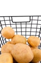 Potatoes in black metallic mesh basket. Storage for food, vegetables and fruits