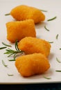 Raw potatoes croquettes and rosemary spice