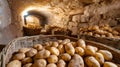 Potatoes filling baskets in rustic underground root cellar Royalty Free Stock Photo