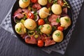 Potatoes with fried bacon and tomato on a plate, top view Royalty Free Stock Photo