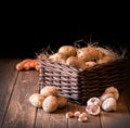 Potatoes garlic carrot vegetable still life raw food wicker basket rustic wooden floor