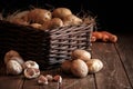 potatoes garlic carrot vegetable still life raw food wicker basket rustic wooden floor