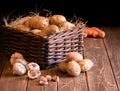 potatoes garlic carrot vegetable still life raw food wicker basket rustic wooden floor