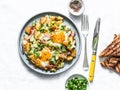 Potatoes, ham, eggs breakfast hash on a light background, top view. Delicious, nutritious breakfast, snack