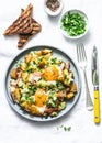 Potatoes, ham, eggs breakfast hash on a light background, top view. Delicious, nutritious breakfast, snack