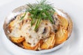 Potatoes with mushrooms in foil white background mayonnaise cheese