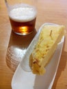 Potatoes omelette pincho de Tortilla de patata and cana (beer). Basque Country cuisine.