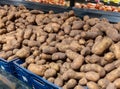 Potatoes and other vegetables on farmers market. Pile of newly harvested fresh potatoes on the supermarket shelf Royalty Free Stock Photo